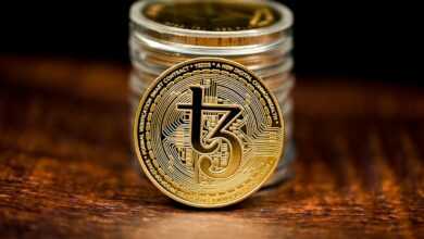 a stack of coins sitting on top of a wooden table