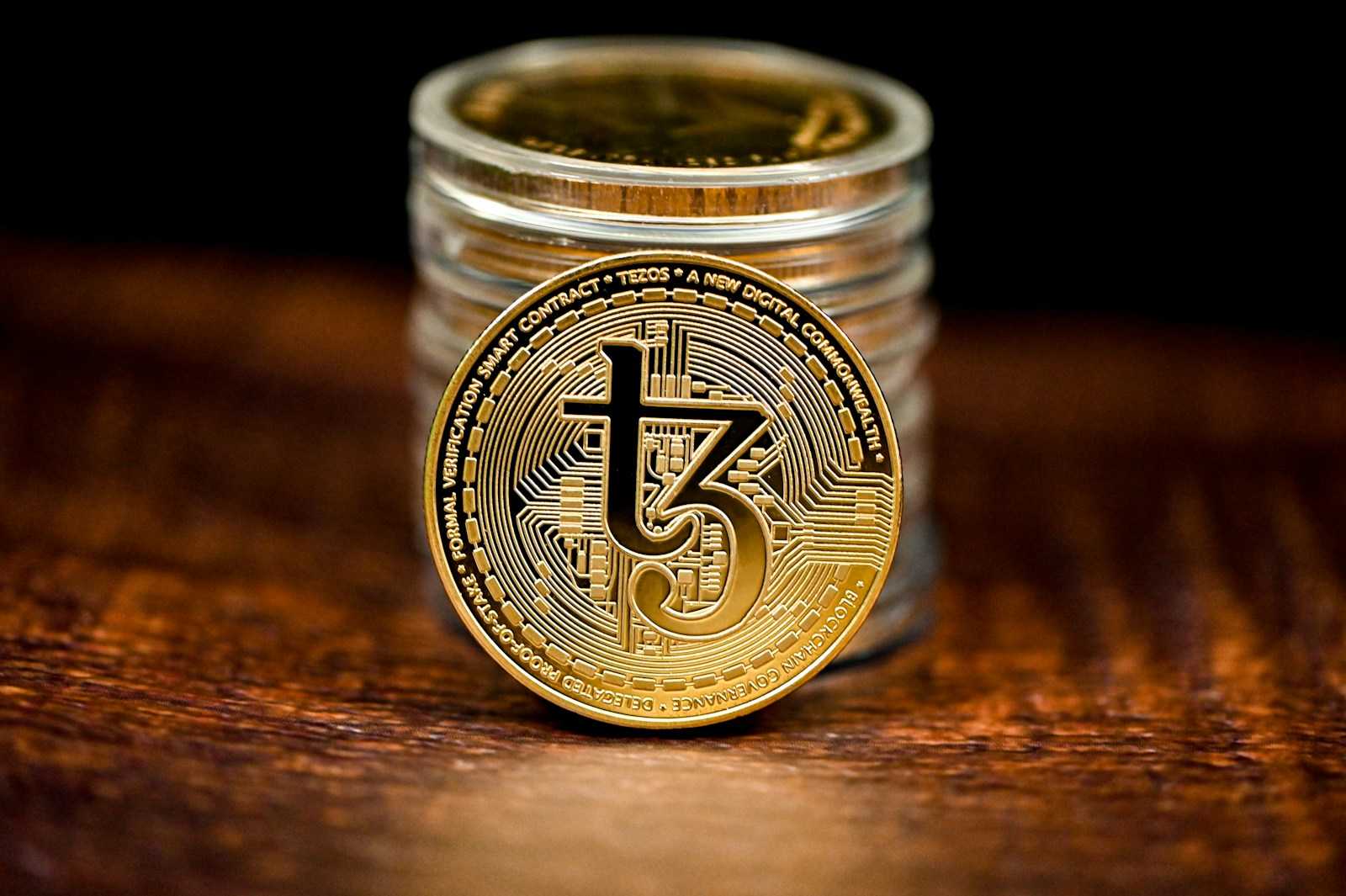 a stack of coins sitting on top of a wooden table