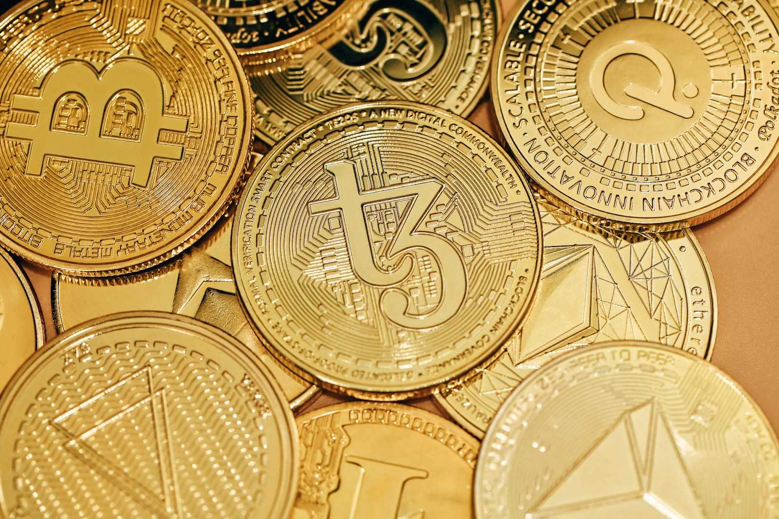 a pile of gold bitcoins sitting on top of each other