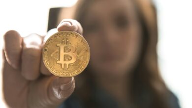 woman holding Bitcoin