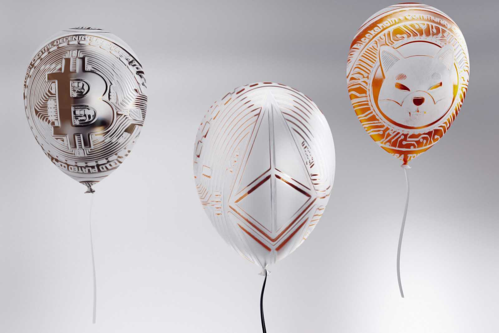 a group of three balloons with a cat design on them