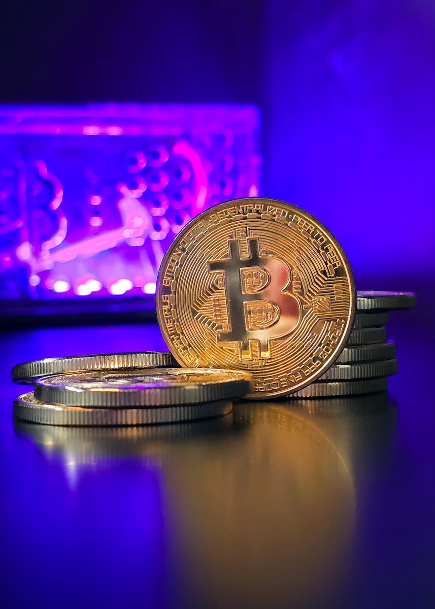 a stack of gold bitcoins sitting on top of a table