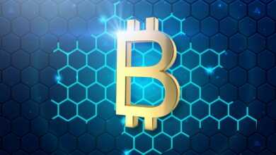 a golden bitcoin on a blue hexagonal background