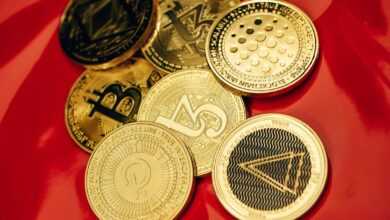 a pile of bitcoins sitting on top of a red table