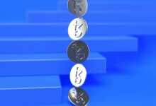 a group of three metal numbers sitting on top of a blue surface