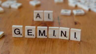 A wooden table topped with scrabble tiles that spell out the word all gen